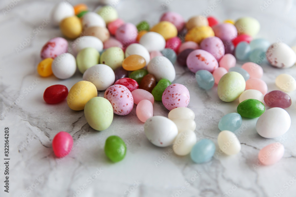 Happy Easter concept. Preparation for holiday. Easter candy chocolate eggs and jellybean sweets on trendy gray marble background. Simple minimalism flat lay top view copy space. Happy Easter concept. Preparation for holiday. Easter candy chocolate eggs and jellybean sweets on trendy gray marble background. Simple minimalism flat lay top view copy space.