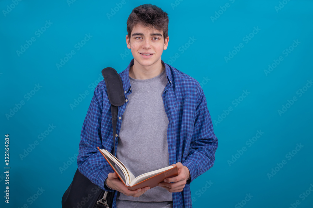 teen student boy with backpack and books isolated on color background teen student boy with backpack and books isolated on color background