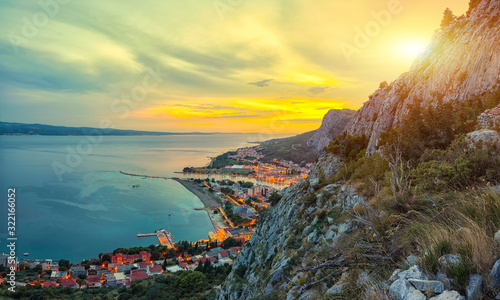 Beautiful aerial panoramic view of Cetina river, mountains and Old town Omis at sunset