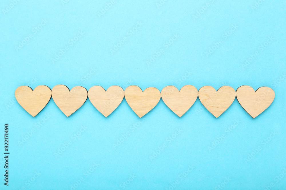 Brown wooden hearts on blue background Brown wooden hearts on blue background