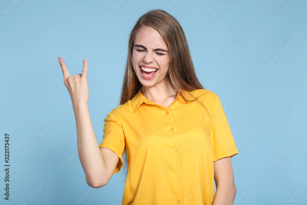 Young beautiful girl showing a gesture on blue background Young beautiful girl showing a gesture on blue background