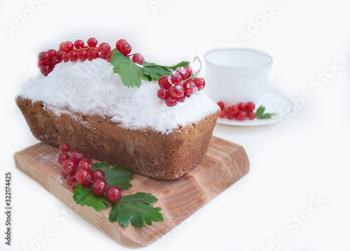 cupcake sprinkled with icing sugar and decorated with currants
