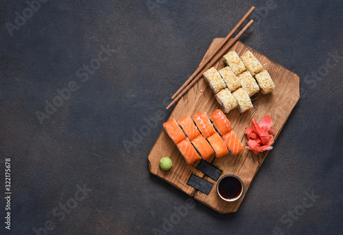 Different types of sushi served on a wooden board. Sushi menu. Japanese food.