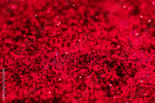 Red glitter texture. Festive sparkling sequins background closeup. Wpaper for Valentine  New Year or Christmas Holidays.