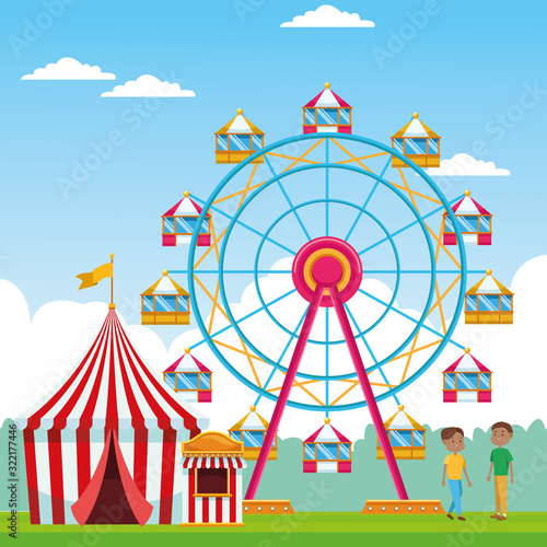 Happy boys in the fair with ferris wheel and fair tent over landscape background