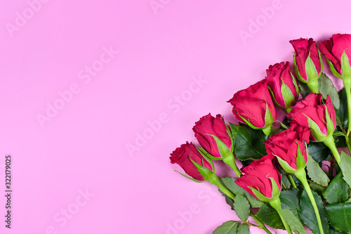 Bouquet of romantic red rose flowers on pink background with blank copy space