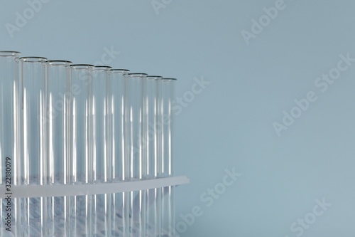 A horizontal image of a removed transparent test tube fragment on a blue background on the left.