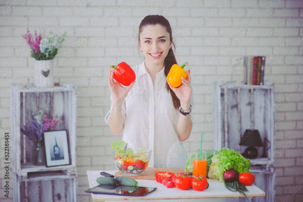 Pretty girl preparing fresh vegetable salad in her kitchen Pretty girl preparing fresh vegetable salad in her kitchen