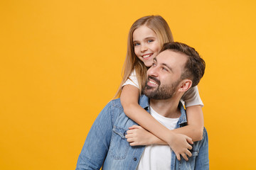 Cheerful bearded man in casual clothes have fun with cute child baby girl. Father little kid daughter isolated on yellow background in studio. Love family day parenthood childhood concept. Hugging.