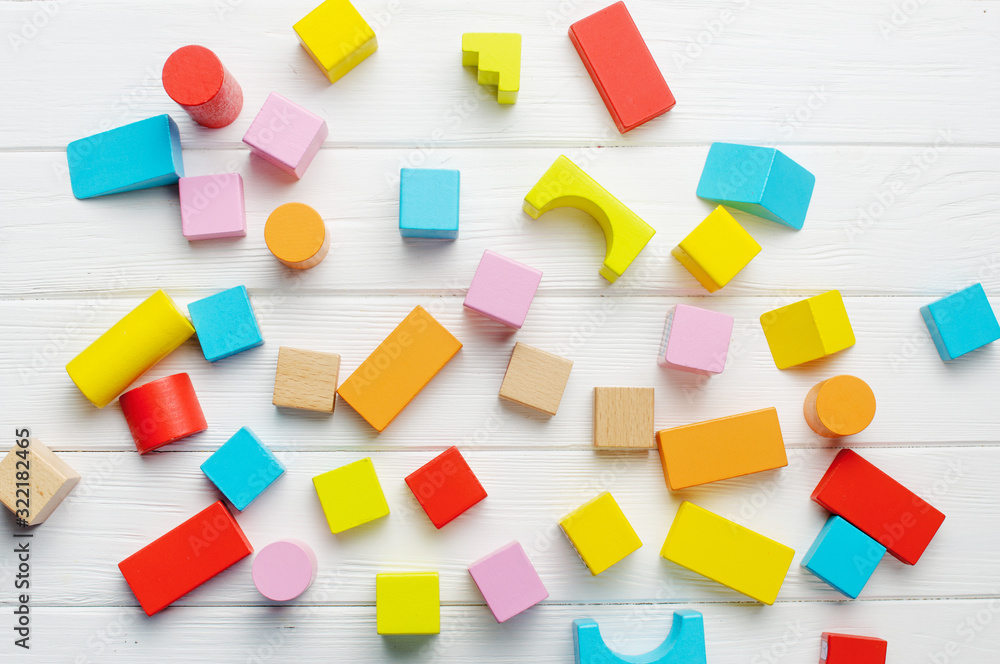 Wooden toys bricks on white wooden background Wooden toys bricks on white wooden background