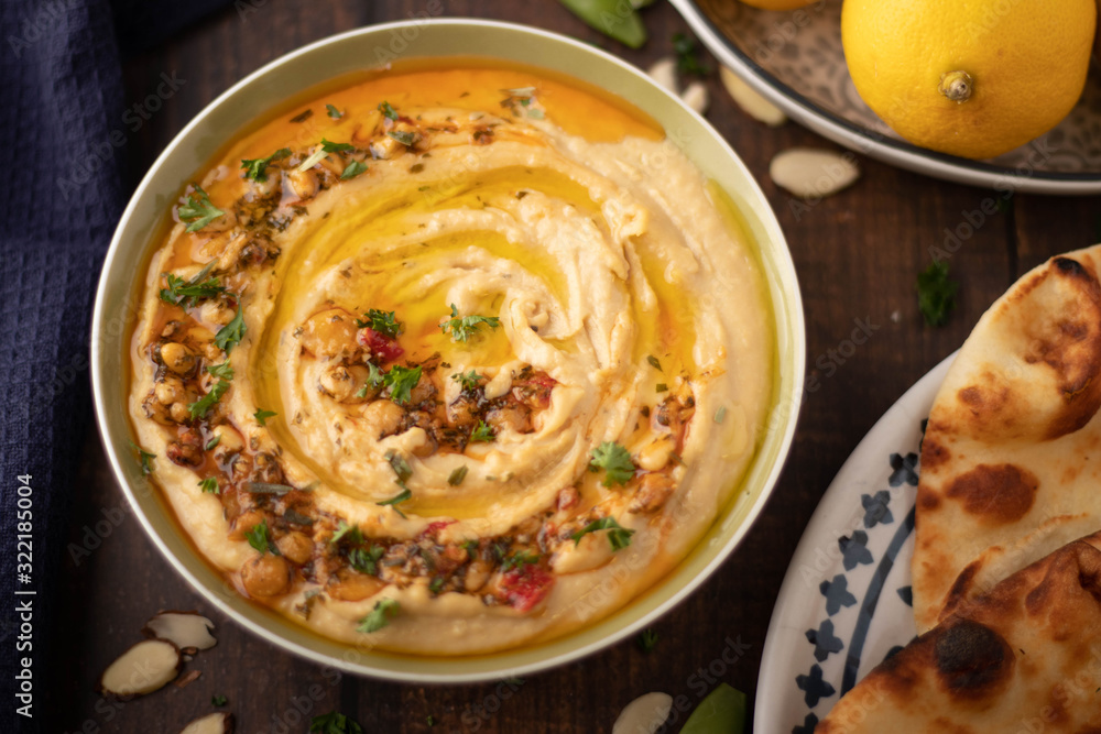 Bowl of Hummus with Bread and Lemons