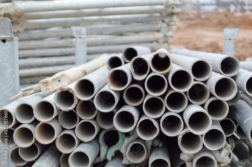 Large iron metal sewer plumbing pipes of large diameter for the industrial construction of water supply or sewage at a construction site during the repair