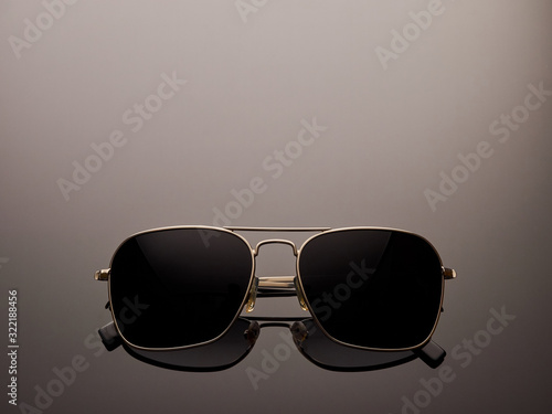 Stylish polarized mirrored almost round sunglasses with metal frame and folded ear arms. Logos removed.