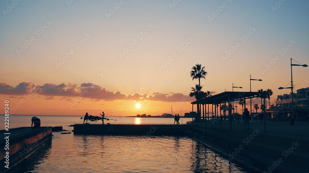 Fototapeta premium Paphos, Cyprus tropical resort embankment at beautiful colorful sunset. Mediterranean vacations and travel concept, copy space