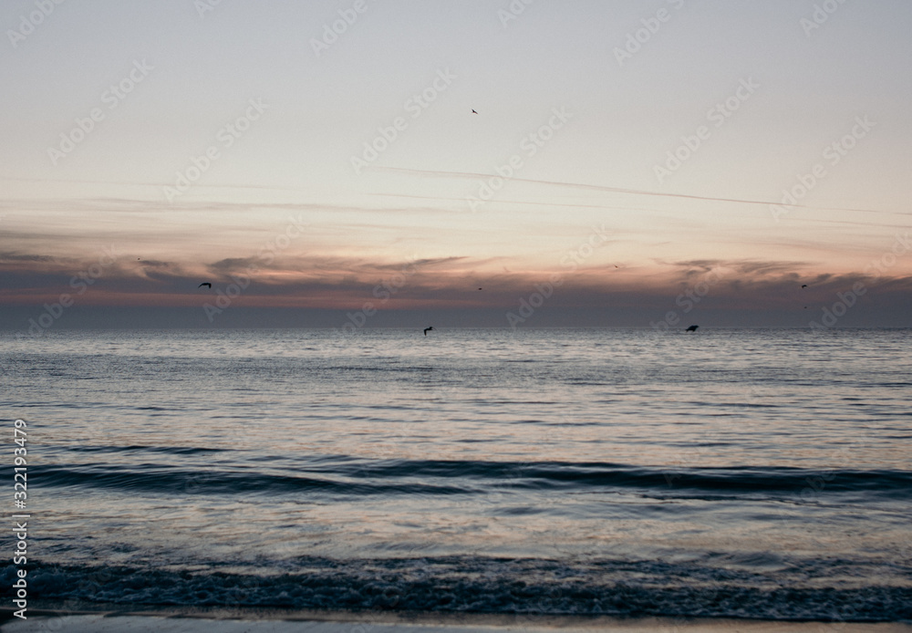 Colorful ocean beach sunrise.