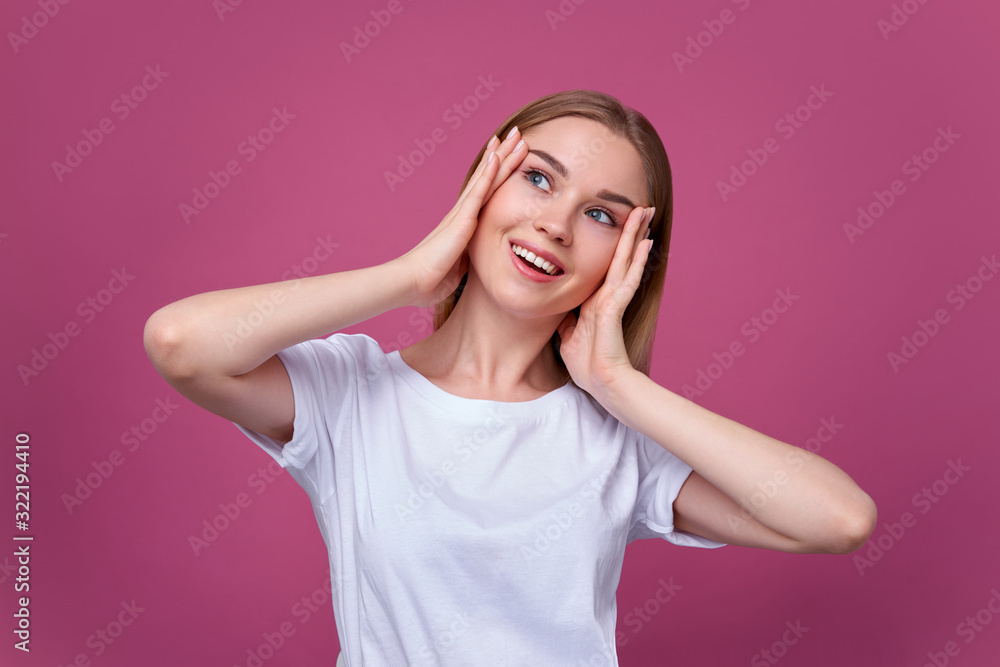 Beautiful smiling young woman touching her head Beautiful smiling young woman touching her head