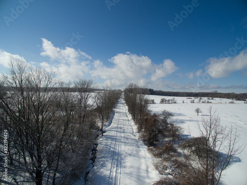 Rural winter landscape with snow and forest and road © David Katz