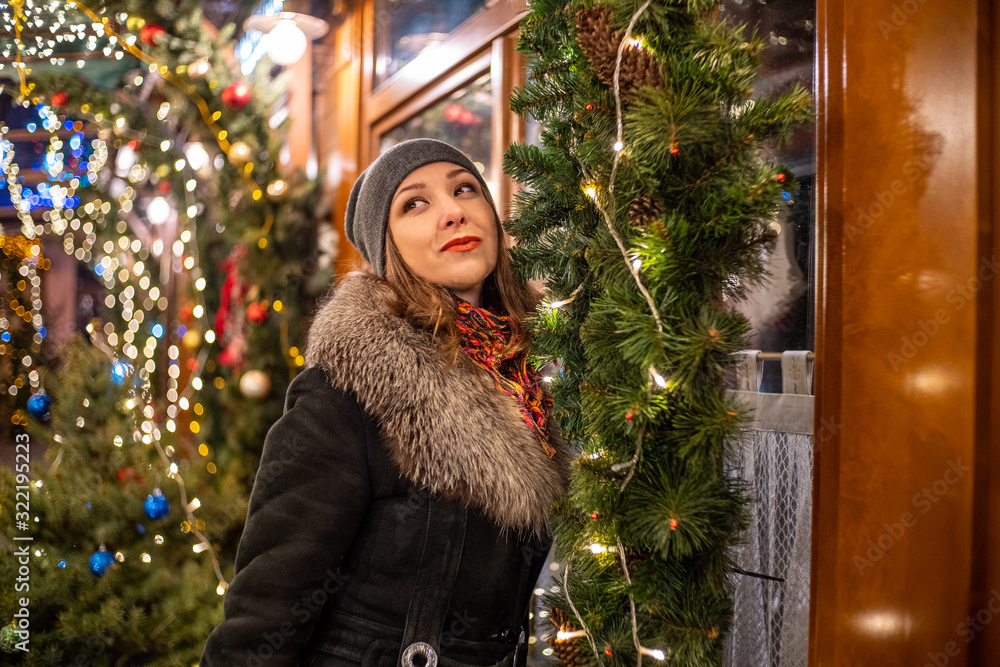 Young attractive girl in new year decorations on the street in winter Christmas holidays Young attractive girl in new year decorations on the street in winter Christmas holidays