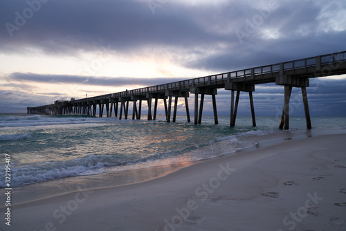 Scenic Sunset View of Panama Beach Pier in Panama City Florida with Crashing Waves