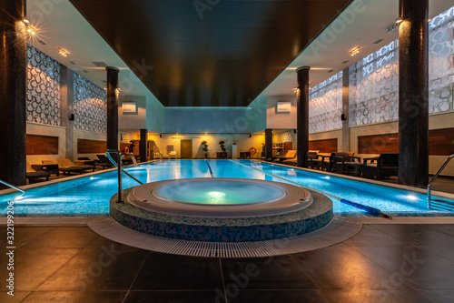 Modern blue on light backdrop. Trendy design. Water - swimming pool. Blue luxurious swimming pool in modern style on light background. Water - swimming pool. Modern design. Night club. Trendy design.