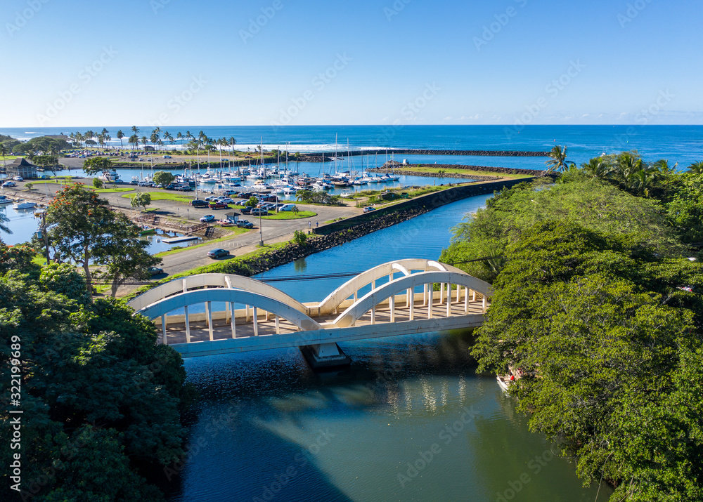 Aerial shot of the river Anahulu and the twin arched road bridge in the North Shore town of Haleiwa