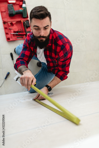 Young bearded repairman working in home. © hedgehog94