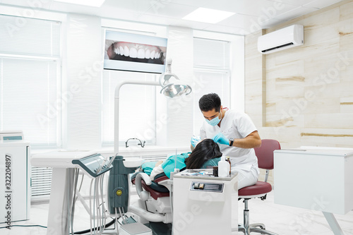 Cute young girl is being examined by the dentist © Anischenko