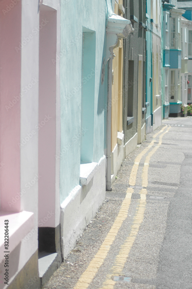 Row of painted houses in pastel shades on a sunny street