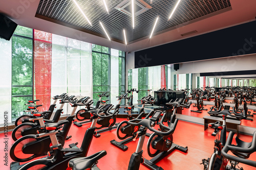 Stationary Spinning bicycles. Indoor cycling for lifestyle design. Fitness background. Healthy lifestyle background. Spinning class with empty bikes. Sport background. Sport, recreation, lifestyle