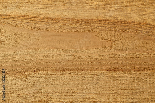High angle view rough surface of natural untreated wooden board texture and background.  Fresh new light red brown lumber with horizontal striped pattern.