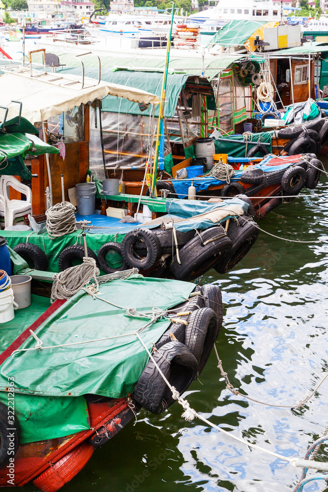 Fishing boats dock at the busy harbor in Sai Kung, Hong Kong, a town famous for its quaint fishing villages and the floating seafood market
