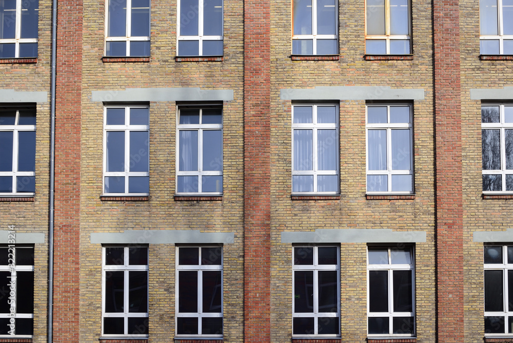 Facade of an old brick factory building with a window front in Augsburg / Germany Facade of an old brick factory building with a window front in Augsburg / Germany