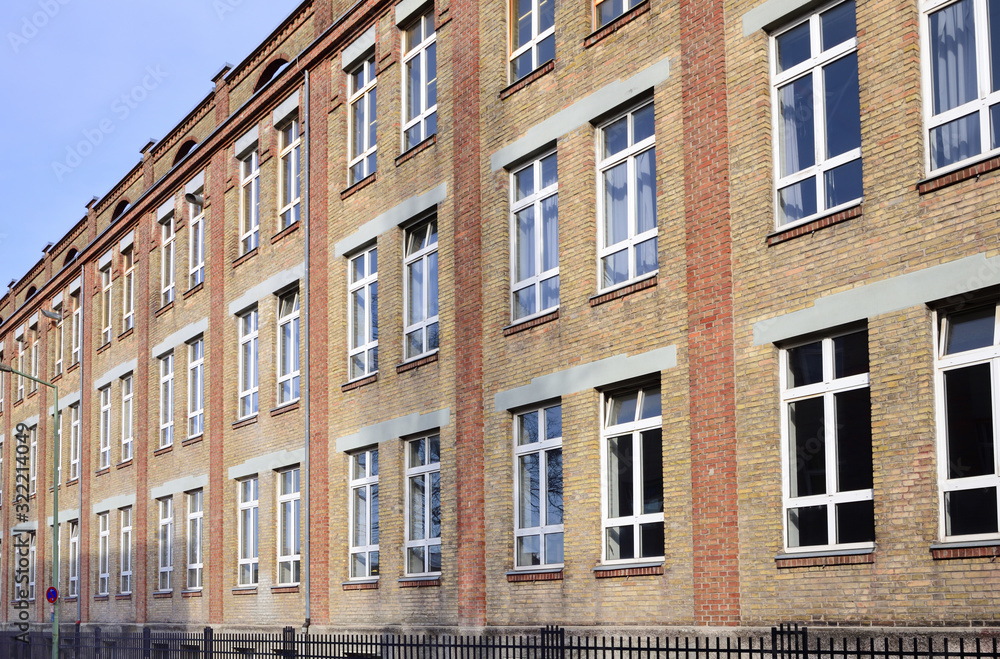 Facade of an old brick factory building with a window front in Augsburg / Germany