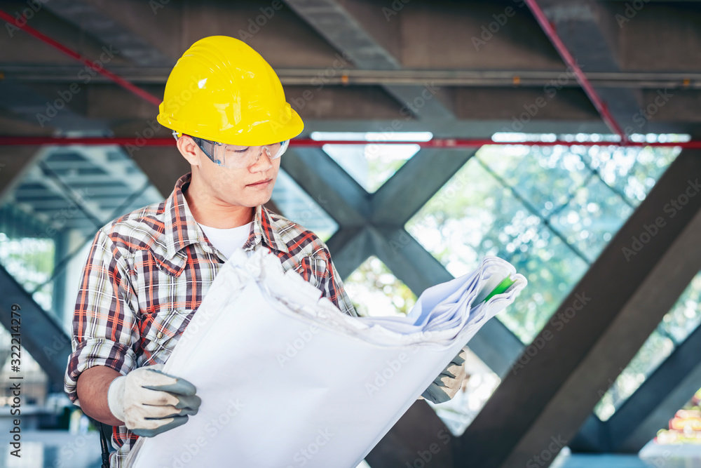 Engineers look at the blueprints at the construction site. Engineers look at the blueprints at the construction site.