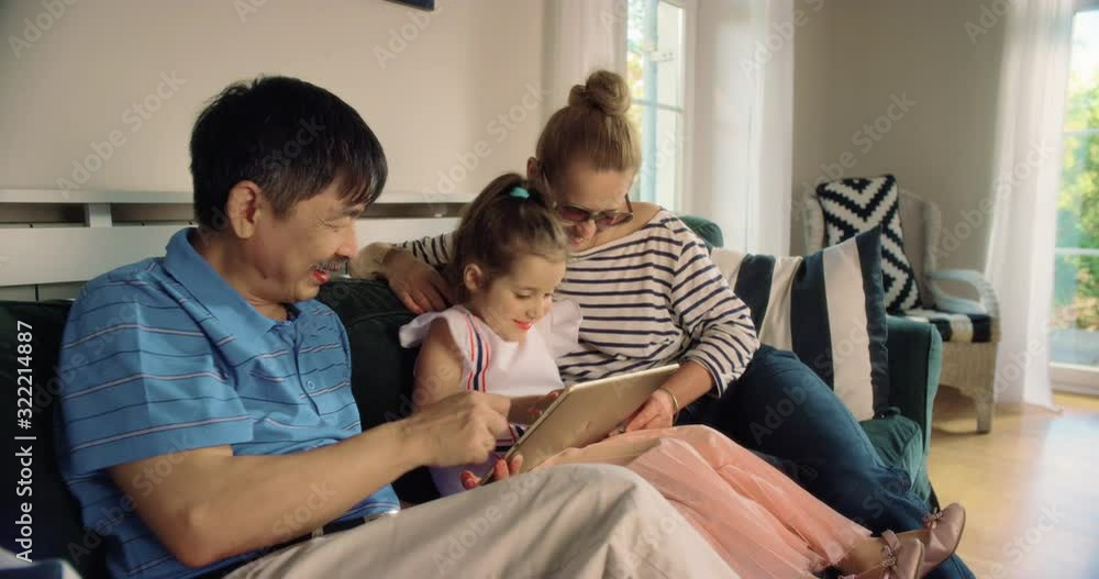 WS Grandparents Using Tablet with Granddaughter. Shot in R3D (6K RED RAW) WS Grandparents Using Tablet with Granddaughter. Shot in R3D (6K RED RAW)