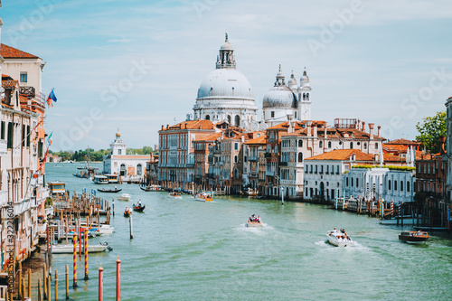 Venice, Italy. Daily boat and tourist hectic on Grand Canal and Basilica Santa Maria della Salute