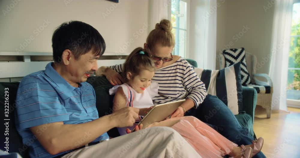 WS Grandparents Using Tablet with Granddaughter. Shot in R3D (6K RED RAW) WS Grandparents Using Tablet with Granddaughter. Shot in R3D (6K RED RAW)
