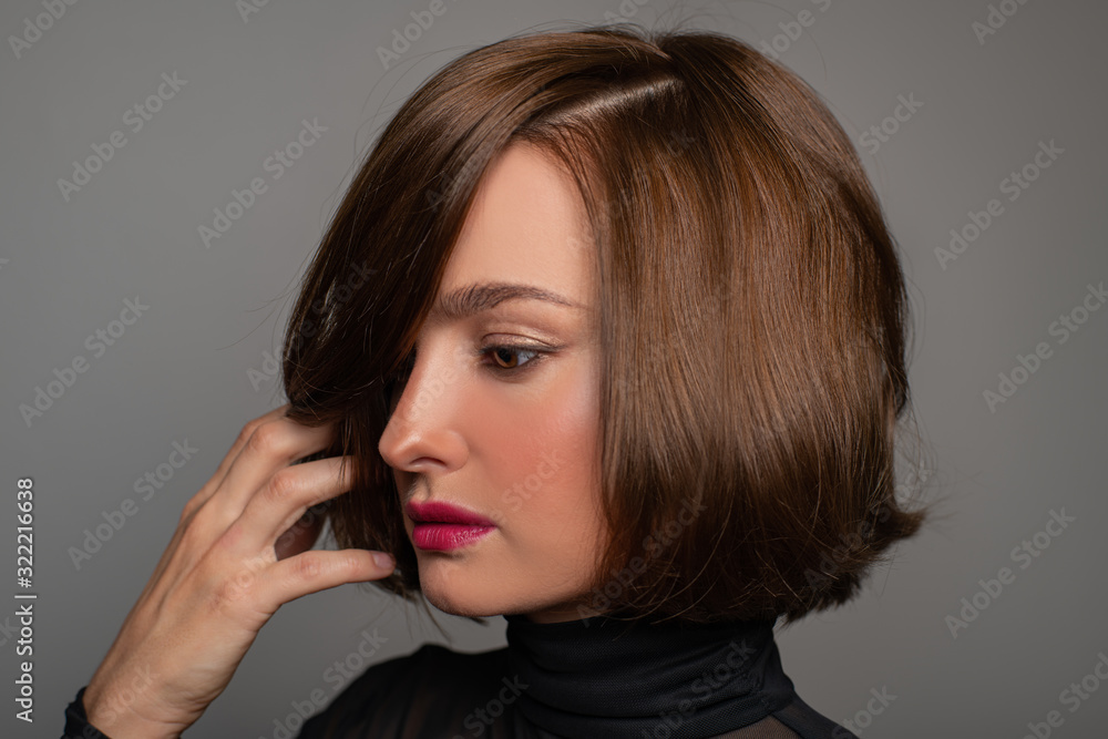 Brunette girl with shiny hair. Beautiful woman with bob haircut Brunette girl with shiny hair. Beautiful woman with bob haircut