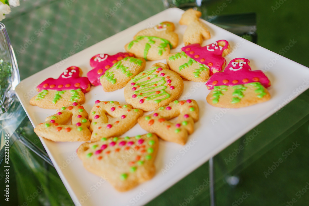 New Year's treats. New Year cookies in the form of men lie on a white plate