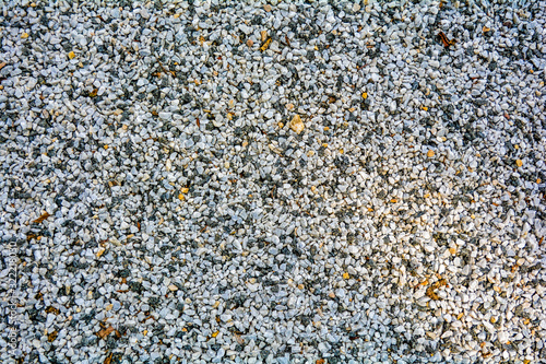 Small White pebble background. Top view of white and yellow gravel stone texture