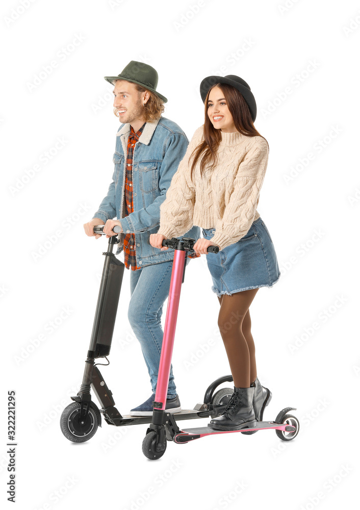 Young couple with kick scooters on white background Young couple with kick scooters on white background
