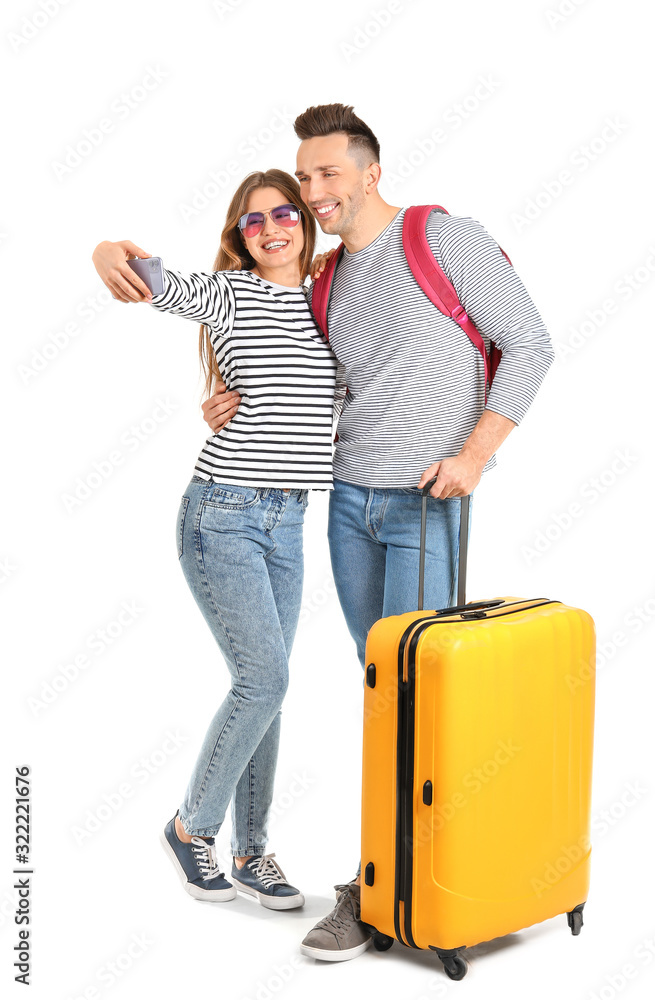 Couple of tourists with luggage taking selfie on white background Couple of tourists with luggage taking selfie on white background
