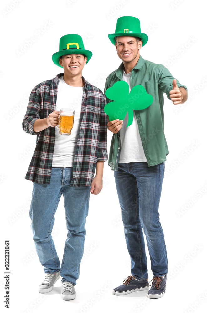 Young men with beer and clover on white background. St. Patrick's Day celebration Young men with beer and clover on white background. St. Patrick's Day celebration