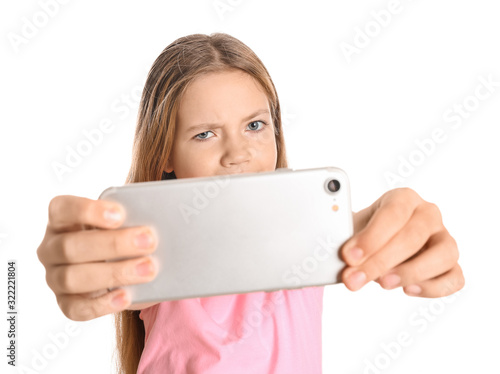 Cute little girl taking sel...