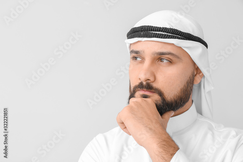 Handsome Arab man on light background photo