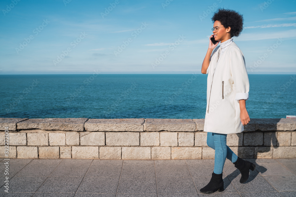 Latin woman talking on the phone. Latin woman talking on the phone.