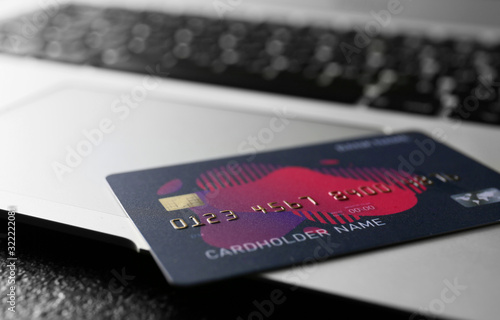 Credit card with laptop, closeup