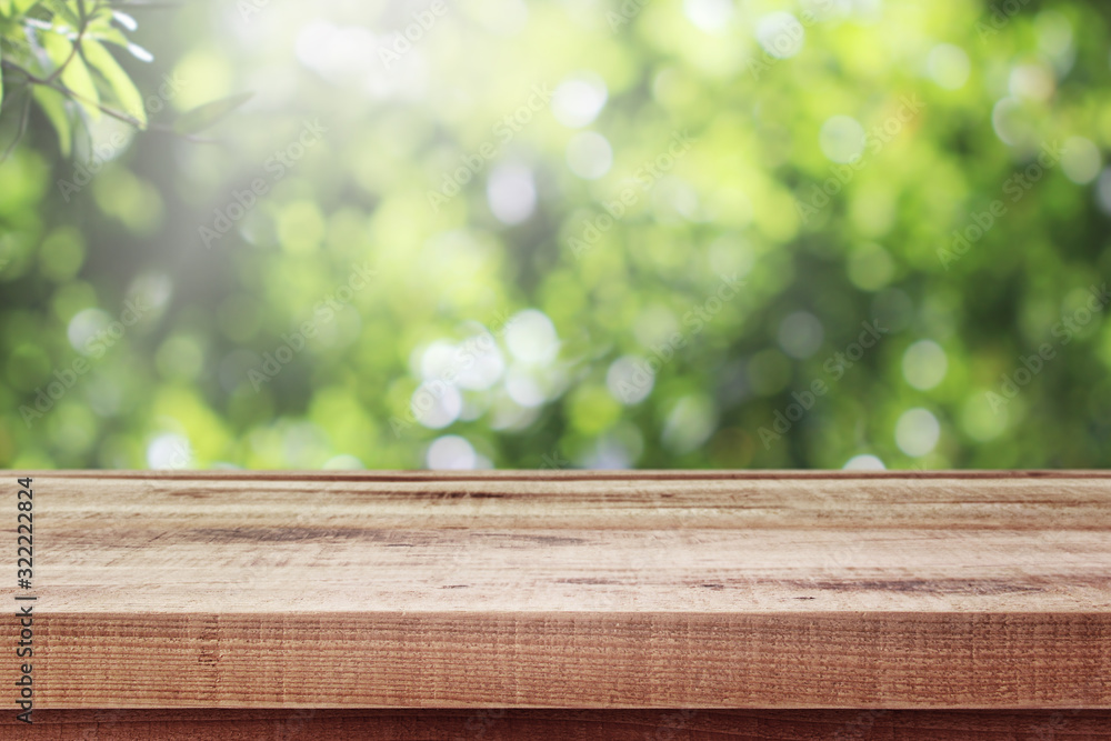 Wooden table and blurred fresh garden nature bokeh background. Wooden table and blurred fresh garden nature bokeh background.