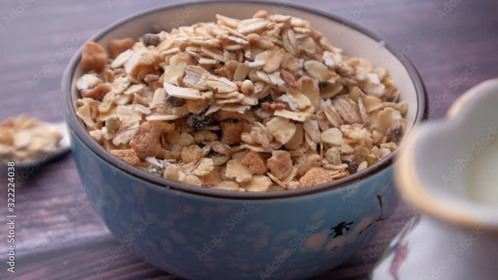 oats in a bowl with milk on table, closeup oats in a bowl with milk on table, closeup