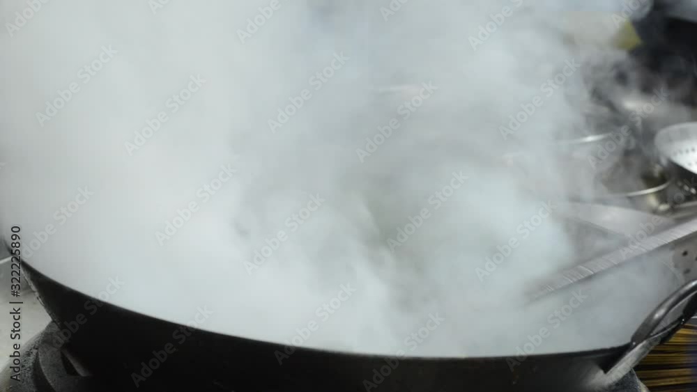 Chef Cooking Stir Fried Dish In Wok - close up Chef Cooking Stir Fried Dish In Wok - close up